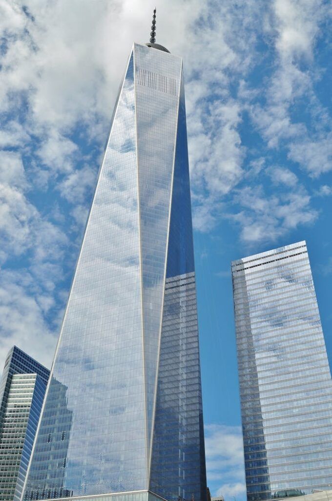 one world trade center manhattan owtc new york 53212 A striking view of One World Trade Center reflecting clouds in New York City.