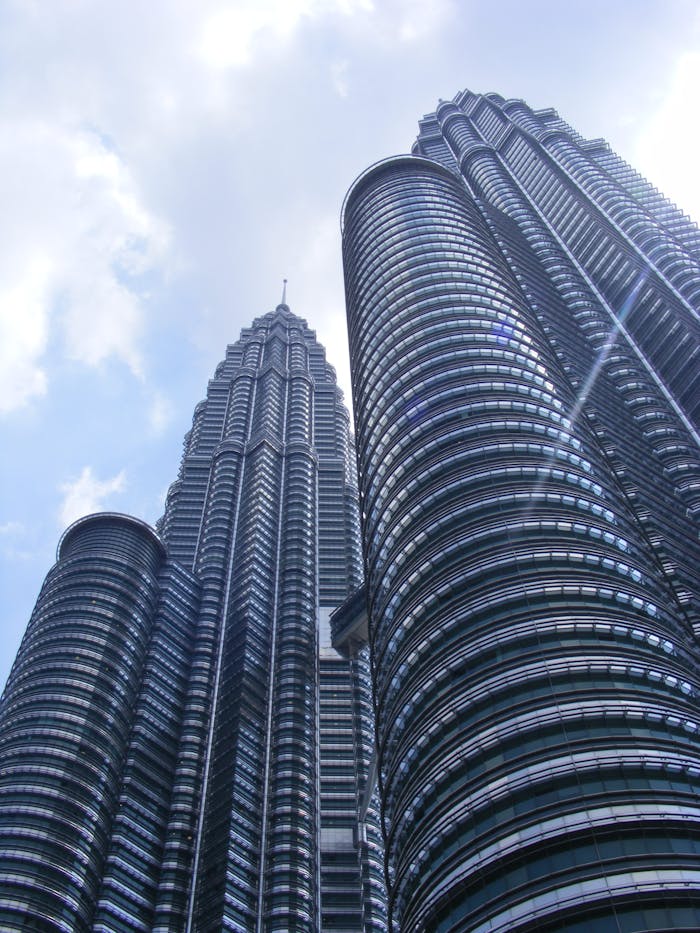 petronas towers skyscraper kuala lumpur petronas twin towers 51944 Majestic view of the iconic Petronas Twin Towers in Kuala Lumpur during daytime.